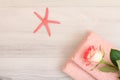 Stack of soft terry towels with flower and sea star on wooden boards Royalty Free Stock Photo