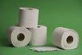Of a stack of soft toilet paper rolls on a green background