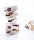 Stack of Soft white nougat with almonds and cranberries on white background Royalty Free Stock Photo