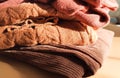 A stack of soft wool sweaters glows in natural light. The image evokes autumn comfort and gentle homey atmosphere Royalty Free Stock Photo
