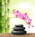 Stack of spa stones with orchid pink flowers and bamboo Royalty Free Stock Photo