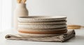 Stack of Ceramic Plates on Linen Napkin Royalty Free Stock Photo