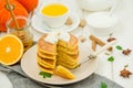 Stack of spicy pumpkin pancakes on a plate with honey and whipped cream on a white wooden background. Royalty Free Stock Photo