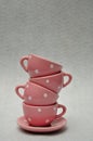 A stack of spotted porcelain tea cups on top of a plate Royalty Free Stock Photo