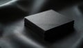 Stack of square black cards on textured black leather surface. Close-up shot emphasizes minimalist elegance, sophisticated Royalty Free Stock Photo