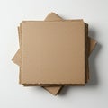 A stack of square, brown corrugated cardboard sheets sits on a white surface. The Royalty Free Stock Photo