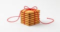 Stack of Square Cookies Tied with Red String on White Background Royalty Free Stock Photo