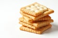 Stack of square crackers on plain white background. Crispy baked biscuits piled up, ideal for quick snack or party appetizer. Royalty Free Stock Photo