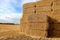 A stack of square hay bales in a farmers field Royalty Free Stock Photo