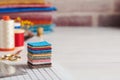 Stack of square pieces of colorful fabrics, accessories for quilting