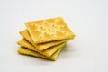 Stack of square saltine crackers isolated on white