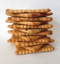 Stack of square salty crackers on white background