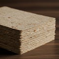 A stack of square sheets, likely made from a fibrous material, is neatly arranged. The Royalty Free Stock Photo