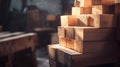 Stack of square timber planks creating warm light and shadow effect in workshop Royalty Free Stock Photo
