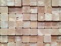 Stack of square wood planks for construction in warehouse