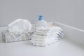 A stack of diapers and baby supplies on white changing table Royalty Free Stock Photo