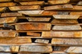 Stack of stacked Lumber. Dried wood boards with a crack.