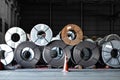 Stack of steel coil in storage warehouse. Steel coils handling equipment. Steel warehouse and logistics operations.