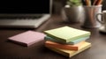 A stack of sticky notes sitting on top of a desk next to a laptop Royalty Free Stock Photo
