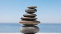 Stack of stones against blurred seascape. Zen concept