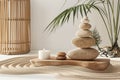 Stack of stones balancing creating zen atmosphere on sand with candle Royalty Free Stock Photo