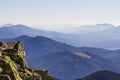 Stack of stones covered with moss on top of a mountain on mountains background. Concept of balance and harmony. Stack of zen rocks Royalty Free Stock Photo