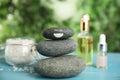 Stack of stones with drawn happy face light blue wooden table outdoors. Be in harmony and enjoying your life Royalty Free Stock Photo