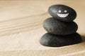 Stack of stones with drawn happy face on sand, space for text. Be in harmony and enjoying your life Royalty Free Stock Photo