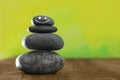 Stack of stones with drawn happy face on wooden table, space for text. Be in harmony and enjoying your life Royalty Free Stock Photo