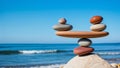 Balanced stone sculpture against a serene beach backdrop Royalty Free Stock Photo