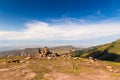 Stack of stones rocks trail marker cairn in the mountains. Against the backdrop of snowy mountains high in the mountains. Royalty Free Stock Photo