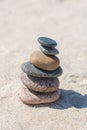 Stack of stones on sand beach near sea. Zen garden. Pebble tower Royalty Free Stock Photo