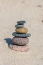 Stack of stones on sand beach near sea. Zen garden. Pebble tower Royalty Free Stock Photo