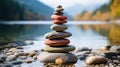 a stack of stones is sitting on the shore of a lake