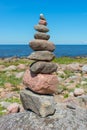 Stack of stones on stone sand beach with sea background. Zen garden. Rock tower Royalty Free Stock Photo