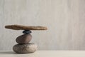 Stack of stones with tree branch on wooden table, space for text. Harmony and balance concept Royalty Free Stock Photo