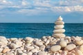 Stack of stones zen pyramid of white pebble on the beach.