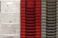 Stack Storage of new colourful white, grey and red plastic container crates Royalty Free Stock Photo