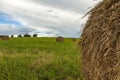 A stack of straw against the background of a field of blue sky and the rays of the sun Royalty Free Stock Photo