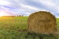 A stack of straw against the background of a field of blue sky and the rays of the sun Royalty Free Stock Photo