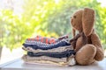 Stack of stylish child clothes and toy bunny