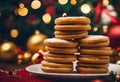 a stack of sugar cookies sitting on a plate next to a christmas tree Royalty Free Stock Photo