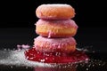 a stack of sugar dusted donuts, one cut to reveal jelly