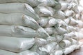 Stack of sugar or flour bags in warehouse