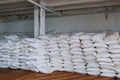 Stack of sugar or flour bags in warehouse