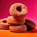 Stack of sugared donuts on an orange background