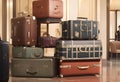 A stack of suitcases arranged in an airport terminal. Suitable for travel concepts, luggage handling, airport scenes, and vacation Royalty Free Stock Photo