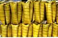 Stack of Suman sa Ibos or steamed glutenous rice wrapped in palm tree or coconut leaves Royalty Free Stock Photo