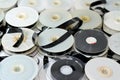 Stack of supply and take up reels with ribbon of VHS video cassette tapes used on old video players and recorders, retro style