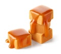 Stack of sweet caramel candy cubes topped with caramel sauce on white background Royalty Free Stock Photo